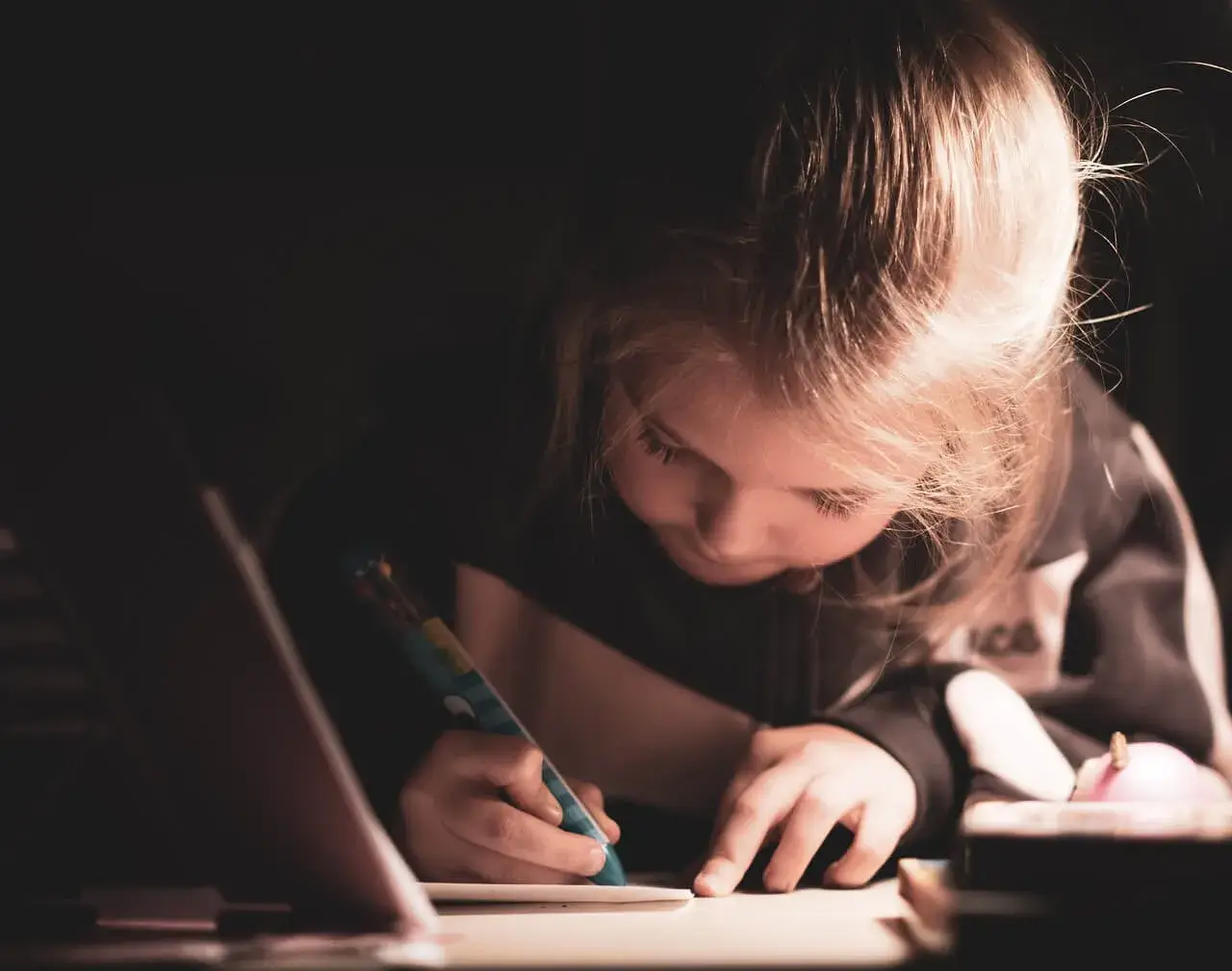 Child focused on writing and learning, representing advocacy and educational support for children with disabilities including autism, ADHD, learning differences, and developmental challenges.